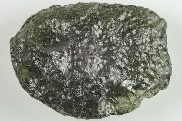 A piece of moldavite tektite showing its distinctive pitting.